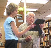 Fred Voss presents June Martin with framed letter from Elie Wiesel