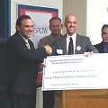 Superintendent Stephen Grimm accepts a $50,500 check from CDC President Doug Firth tech_check_120