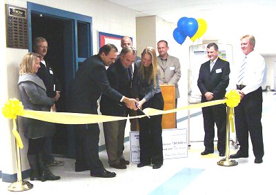 (left to right) Superintendent Stephen Grimm, Middle School Principal Jamie Thomas, and Middle School Technology teacher Nicole Lamie cut the ribbon to open the new tech lab tech_ribbon