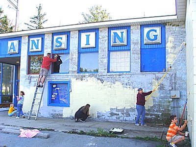 Club members painted the East Shore Skate Park Saturday. Derek Osborne (on ladder) paints the trim. erotary_osborne