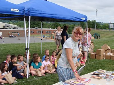 Retired Librarian Sam Foley read stories to each class in the Reading Tent esrc_foley