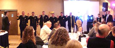 Director of Emergency Response Lee Shurtleff swears in 2011 officers firedeptdinner_swearin400