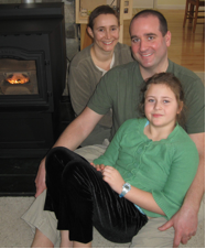 The Ellis Family relaxes by their new efficient pellet stove after receiving the first grant award of the Finger Lakes Climate Fund. flcf_ellis