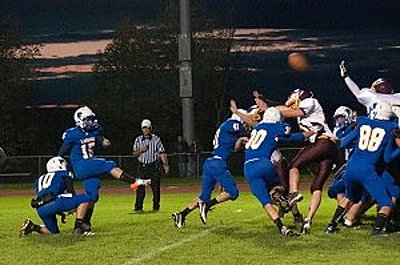 Kicker, #15, Dennis Britton kicking a field goal as the linemen and backs hold off the onslaught of the Golden Eagles Defense. footballv0905_kick