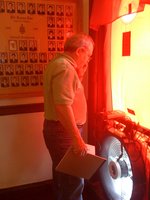 Steve Harris of ASI Energy performs a blower door pressurization test at the Phi Kappa Tau fraternity house. frat150