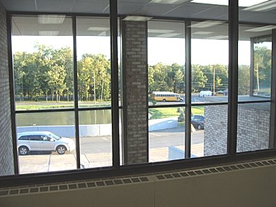 These windows were precariously attached at the top, prompting fear that students could push through them. Now they are secured to the roof of the building at the top, as well as to the wall below. hstour2 window