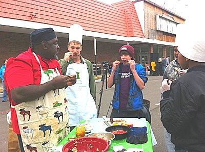 At Ithaca’s first Iron Chef, Jr. Competition on Saturday 10/22, guest chef Ralph of Ralph’s Ribs shows Aidan Hodges, an 11th grade student at New Roots Charter School, some cooking tips. The event was a featured part of Ithaca’s Food Justice Summit event, organized by Greenstar Community Projects. ichef_400
