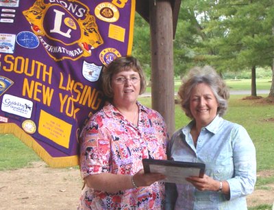 Kathy Miller (right) recieves the Robert J. Uplinger Award from Lansing Lions President Debbie Mann lions_uplingermiller