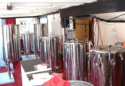 (From front to back) The first tank heats wate, the next one brews the sweet liquid, and the third is for adding hops. The next two are for fermentation, and the last adds the bubbles. rogues_cca_tanks400