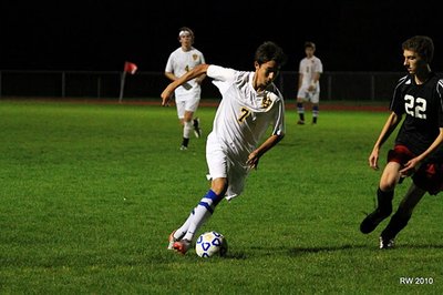 Junior winger WooJin Richardson moves up field, looing to create a seam in the Groton defense during the Bobcats 6-0 rain soaked victory on Wednesday night. Above: Senior striker Andrew Roth celebrates his first career goal with sophomore, Benji Geisler and senior, Troy Hradisky, giving the Bobcats a 6-0 advantage over Groton at Sobus Field Wednesday night. soccer20110930 WooJinGroton