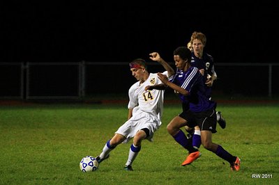Senior winger Troy Hradisky makes a cross to a teammate during the Bobcats 4-0 victory of Dryden. (Shown at top) Junior defender Spencer Warkenton drills a free kick into the Bobcat’s offensive zone during the first half at Lansing’s Sobus Field last Thursday. soccer_10dryden_hradisky