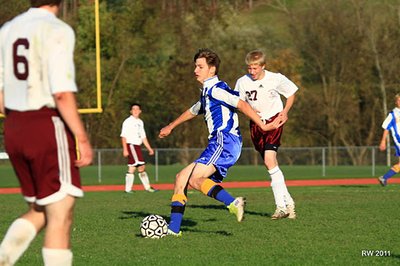 Sophomore defender Clinton Herzog looks up field for an opening in the Whitney Point defense during the Bobcats 8-1 victory. soccer_10wp_herzog