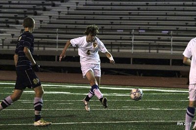 Junior midfielder Cobi Byrne launches a long range shot on the Crusaders net in the first half. soccer_byrneiac2