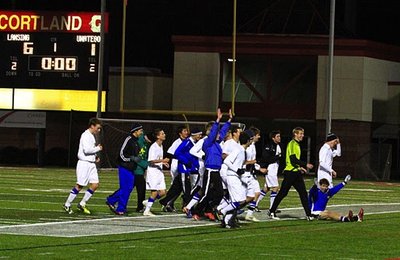 The Lansing Bobcats acknowledge their fans and celebrate their Quarter Final victory over Unatego. Shown at top, sophomore midfielder, Benji Geisler, finishes and follows his first goal of the evening in Lansing’s 6-1 victory. soccer_f1_400