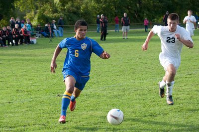 Junior striker Ellington Hopkins prepares to make his game winning cross to Ethan Kutler in Lansing’s 1-0 road victory over Marathon on Friday, September 16th. soccer marathonhopkins