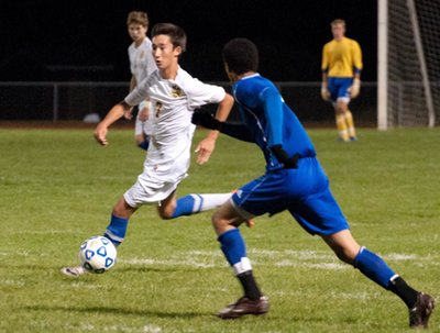 Junior midfielder WooJin Richardson eludes senior Justin Bozeman of Trumansburg High School and heads up field looking for an opening in the Blue Raider defense. soccer tburgrichardson