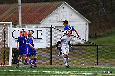 Junior defender, Timmy Arleo goes high to clear a ball from the Lansing box in their Regional Championship game. Shown at top, Junior center back Spencer Warkentin contains a Black Knights defender during the 1st half of their victory last Sunday in Morrisville. soccer_tully_4
