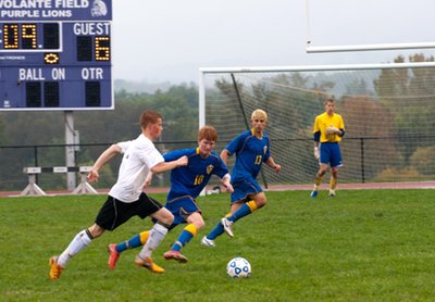 Senior Taylor Schuster defends the Lansing goal while defender Timmy Arleo and keeper Benji Parkes look on. Pictured above: Lansing defender and sophomore, Jacob Palladino looks to serve a ball to the Bobcat offense in last week’s 9-0 drubbing of Dryden. soccerv7i38 SchusterDryden