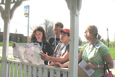 Dewitt Middle School students and their chaperone examine a system map at a TCAT bus stop next to their school before the fourth‑annual Amazing TCAT Race competition Friday morning. tcat_Dewittstudents