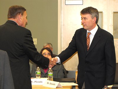 Joe Turcotte (right) is greeted by U.S. Rep. John Mica, R‑Florida before Thursday’s listening session. tcat_turcotte