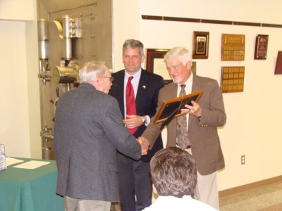 DeWitt Park Restoration/Rededication Committee Chair Holly Hollingsworth (left) recieves an award from Fran Benedict as Greg Hartz looks on tct_excellence_hh400