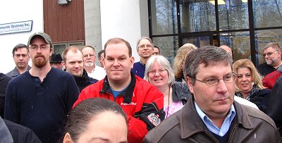 Employees gather to celebrate the ground breaking of the new manufacturing facility. trans_employees