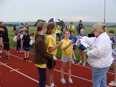 Audrey Hummel hands out ribbons to athletes at the finish line triath_ribbons