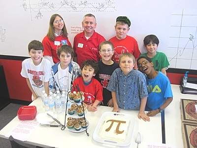 Mathnasium of Ithaca Director Ewan Barr (2nd from left, back row) and young mathematicians eating up Pi pi_group