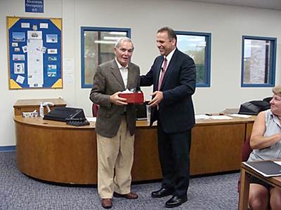 Richard Thaler (left) receives the 'Blue Sneaker' award from Superintendent Stephen Grimm for 'going the extra distance' for the Lansing School District thaler_400