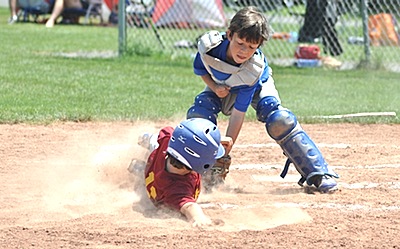 Jacob Ouellette from Lansing places a successful tag on a play at home in the championship game. (Above) Mark Maybee delivering a pitch for Lansing versus Ithaca 3. 10u_jacob400