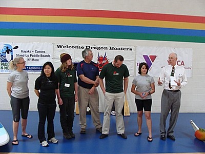 Left to right: Julie Carmalt, Amy Kuo Somchanhmavong, Elisha Speight, Paul Norton, Ray Weaver, Jennifer Miller, Frank Towner announce a collaboration between the Ithaca Y, the Ithaca Dragon Boat Club, and Paddle-N-More ypaddle_alliance