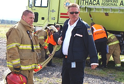 Ithaca Tompkins Regional Airport Operations Supervisor and Fire Chief Dave Crawford (in blue jacket) directing operations apdd crawford