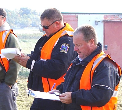Ithaca Airport Emergency Responder Tom Warner (left) and Rochester Airport Fire Chief Todd Bane evaluate the drill apdd evaluators