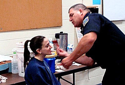 Ithaca Airport Fireman Tom Warner applies stage blood to a crash victim apdd warner-blood