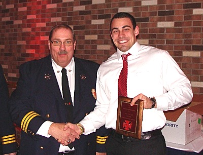 First Assistant Chief Dennis Griffin congratulates Rookie of the Year Trevor Brill fdb_brill_rookieoftheyear