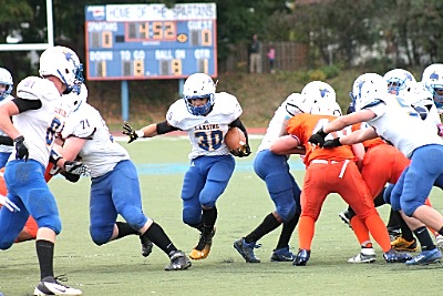 #30 Tim Kelley running through the 2 acre hole created by the Lansing linemen football 1015-50