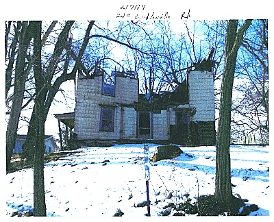 After: only four years later the roof is gone and the floors have collapsed into the basement. Demolition is complicated by asbestos siding. lvhouse_after