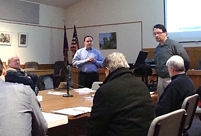 NRP's Chris Dirr (standing center) presents a plan to the Lansing RFP committee. Committee Chairman Daniel Adinolfi is standing at right. nrp_dirr