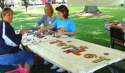 Volunteers crafted one-of-a-kind mosaic signs for Myers Park Playground in 2010 playground_totlot_making