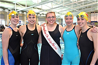 Tompkins County Dairy Princess Elizabeth Drake (center) with Ithaca High School Division IV team swimmers dp ithswim400