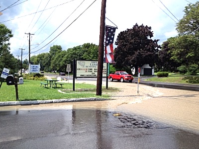 The road in front of the Town Hall and Lansing Community Library was only one part of the Town that was covered in water one year ago. Flooding