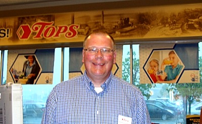 Store Manager Rich Szachta standing in front of the new mural in the Tops vestibule, featuring scenes from Lansing history. Store Manager Rich Szachta standing in front of the new mural in the Tops vestibule, featuring scenes from Lansing history.
