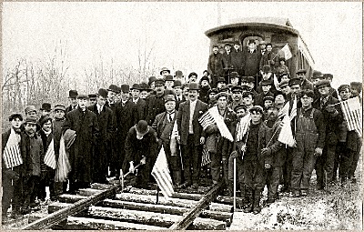 The final spike is driven in the Ithaca Auburn Short Line. An electric trolley service ran from Ithaca to the Rogue's Harbor Inn, and steam engines ran the rest of the way to Auburn. Portions of the railroad bed still exist in the Village and Town of Lansing, including what is now a walking path on the Town Center Trail across the street from the Town ballfields. Ithaca Auburn Short Line