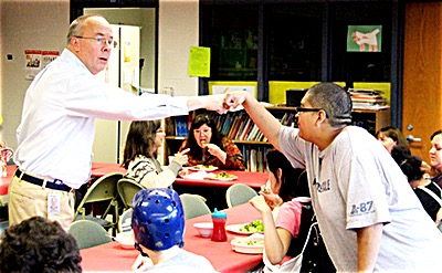 Teacher Paul Hertzog and student Brandon Almonte share gesture of approval after successfully preparing a Thanksgiving meal. tstb Thanksgiving2