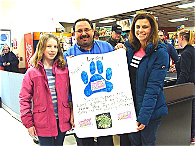 Lansing 5th grader Ashlyn Tarbert presents her original poster to Lansing Market Manager Sandro Mironti (center). Also pictured is PTSO Middle School Vice President Karin Silva (right) Box Tops For Education