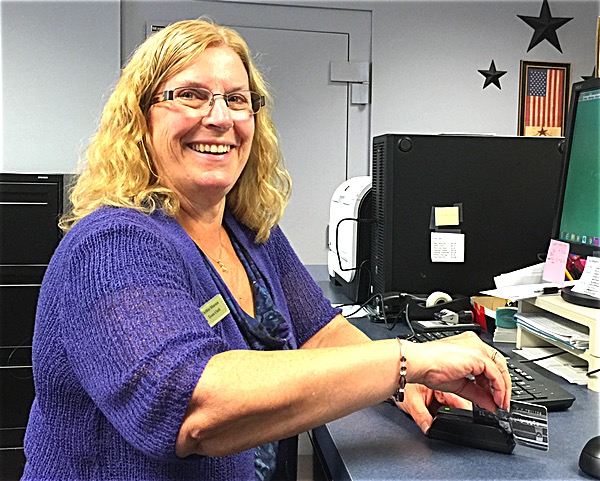 Town Clerk Deborah Munson processing a cxredit card transaction at the Lansing Town Hall Lansing Accepts Credit Cards