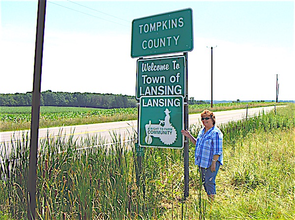 Lansing Agriculture Advisory Committee Chair Connie Wilcox next to one of six new 'Right to Farm Community' signs, entering North Lansing from Cayuga County. Right to Farm Signs