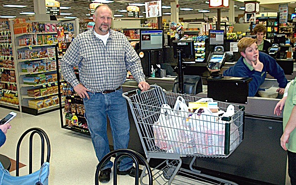 Charlie Purcell with all the groceries he could grab in three minutes at Lansing Market Wednesday. Photo by Ed Siemon. Charlie Purcell