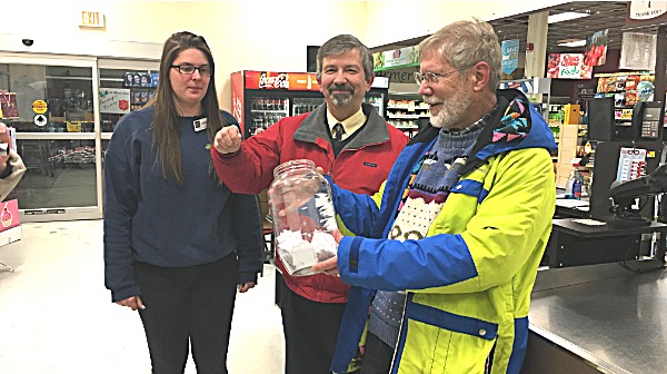Lansing-Ithaca Rotary Club Treasurer Ed Siemon holds a big jar of raffle tickets Monday while Lansing Town Supervisor picks the winner. Charlie Purcell bought the winning ticket. Photo by AnnMarie Hautaniemi. 3 Minute Food Run