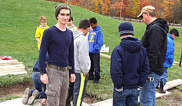 Toby Green (left) with fellow Boy Scouts Saturday, preparing a concrete slab for framing on what will be a covered bicycle rack. Toby Green Eagle Scout Project